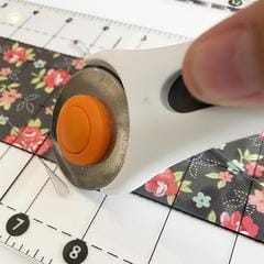 Slot for rotary cutter on ruler